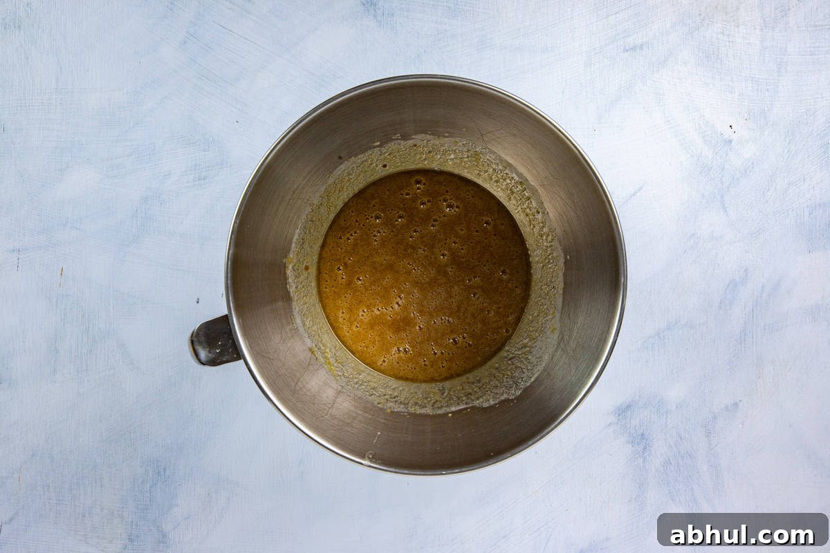 Butter and sugar blended in a mixing bowl.