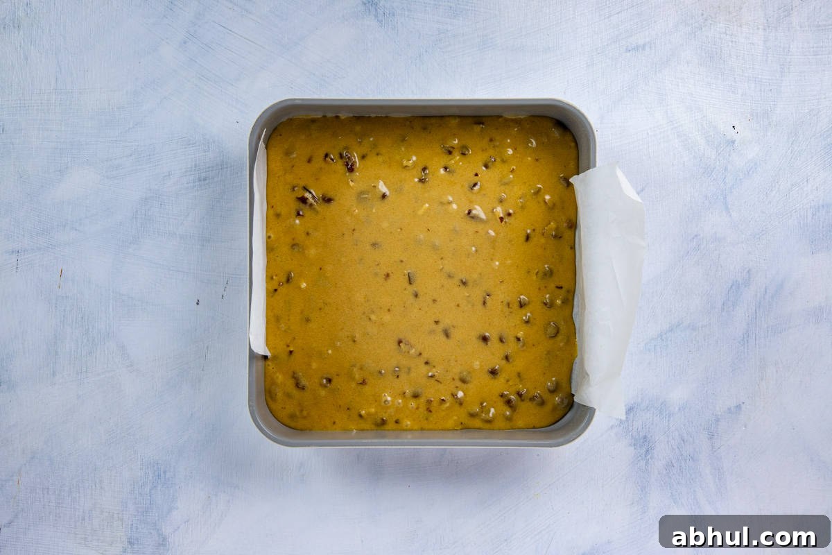 Batter added to the prepared square baking pan.