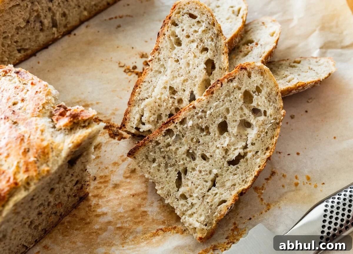 Slices of no knead Italian bread recipe on a wooden cutting board. 