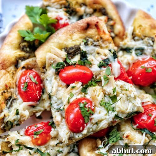 slices of chicken pesto flatbread on a plate.
