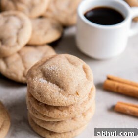 stack of chewy snickerdoodle cookies with cracked tops and cinnamon sugar.