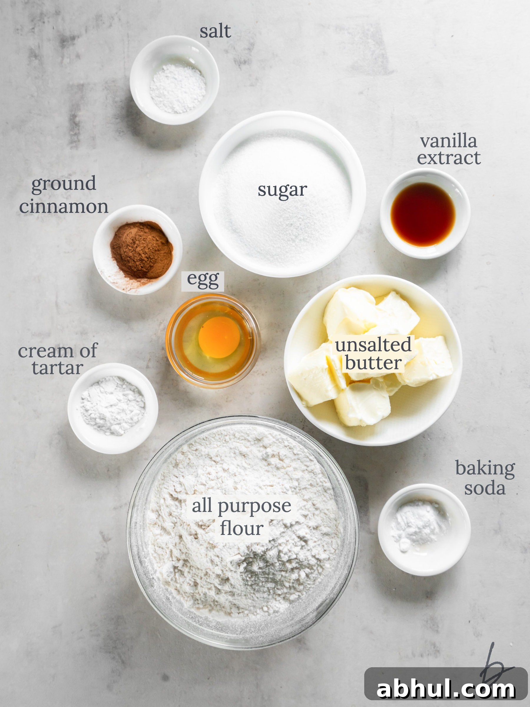 bowls of ingredients to make snickerdoodle cookies.