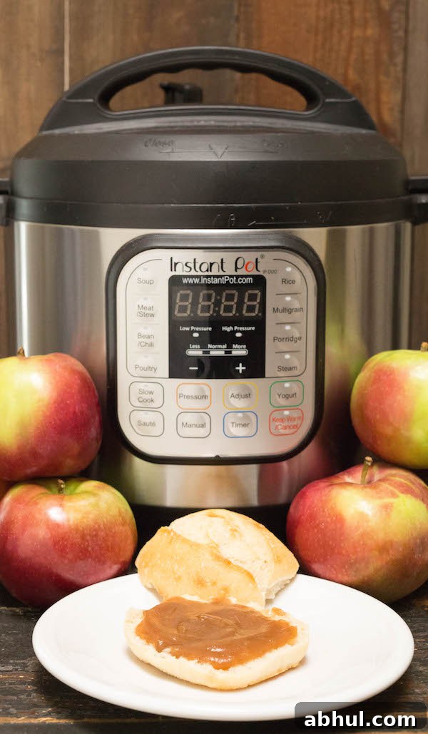 Apple butter on a roll in front of the Instant Pot.