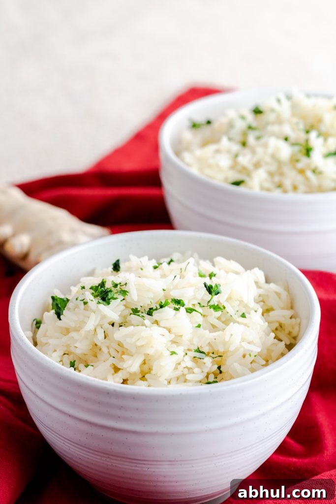 Cilantro jasmine rice on a red napkin in white bowls. 