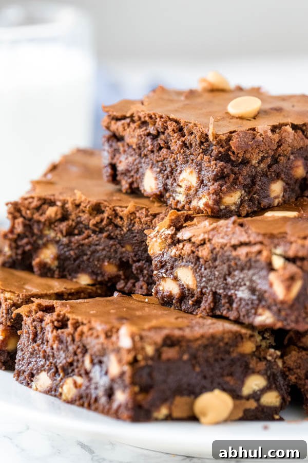 A plate of chocolate peanut butter brownies filled with peanut butter chips.