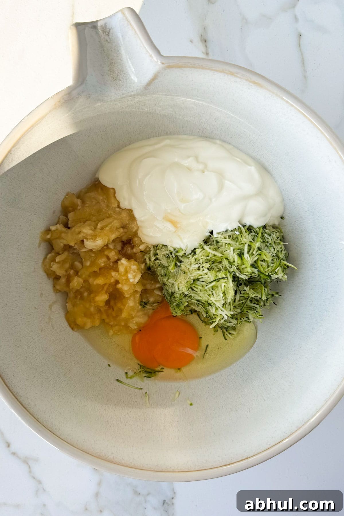 Wet ingredients being mixed in bowl.