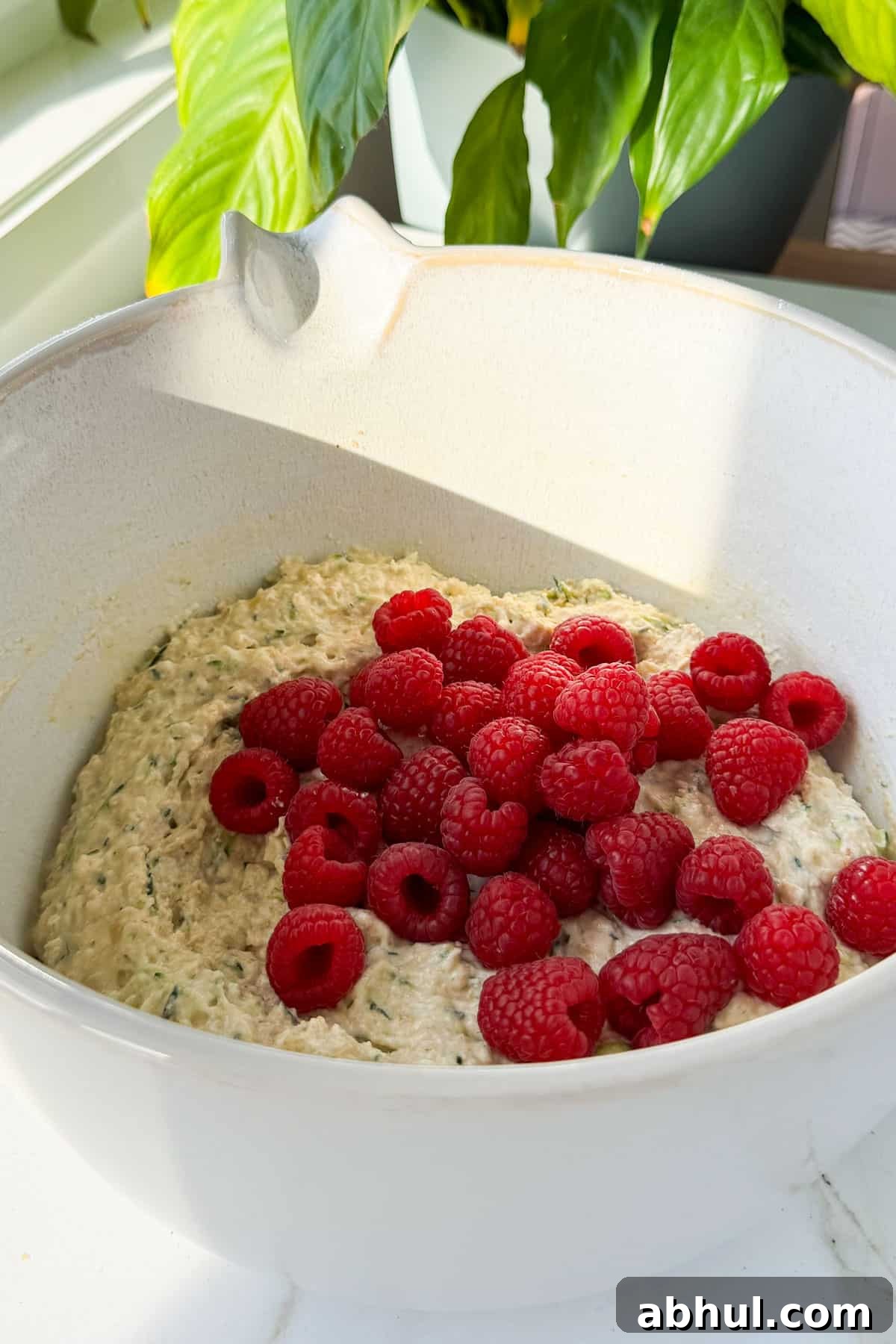 Raspberries added to the mixing bowl.