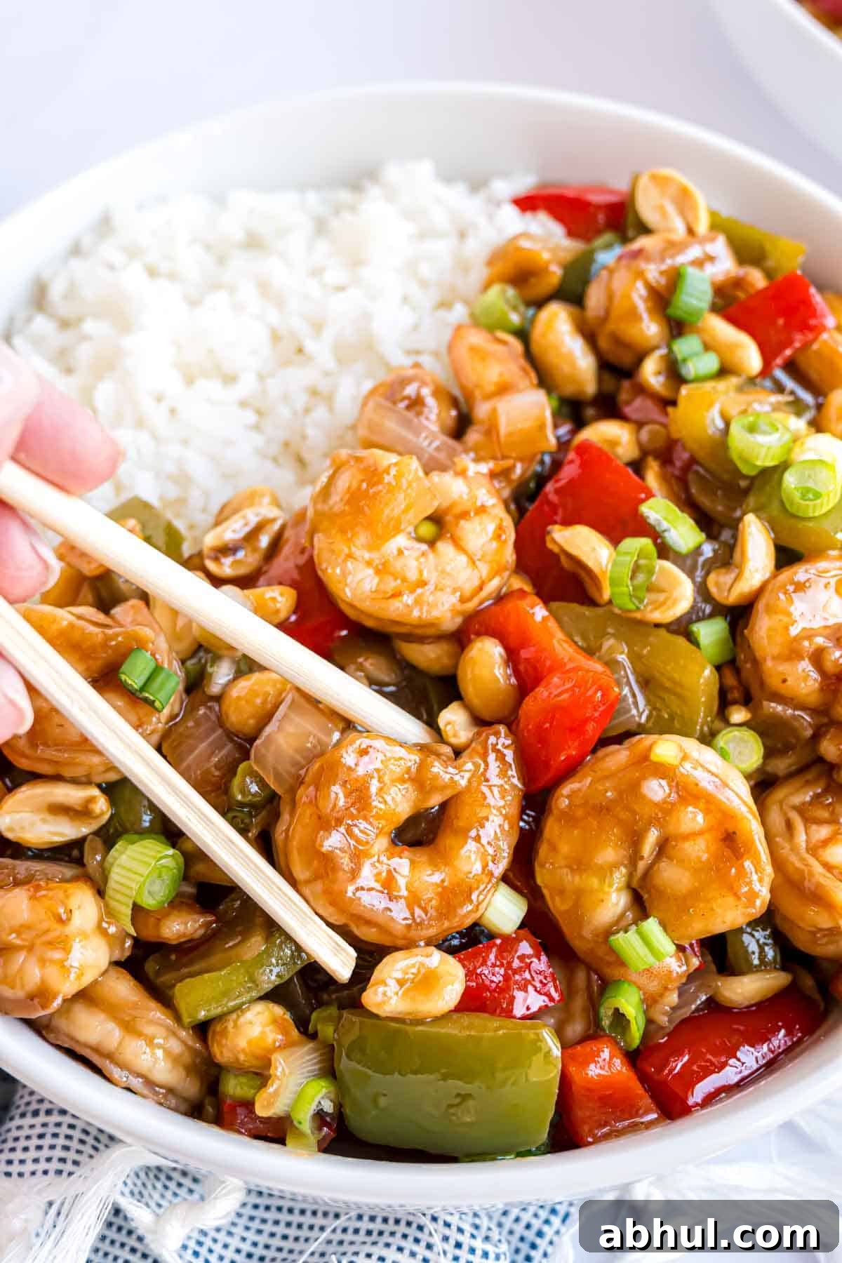Shrimp held between chopsticks.