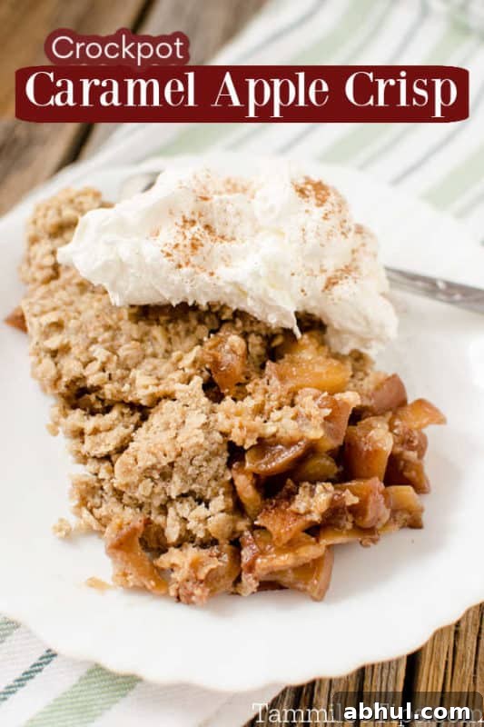 crockpot caramel apple crisp over a white plate with apple crisp and whipped cream 