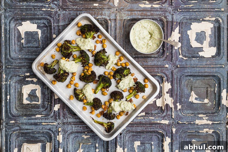 Roasted broccoli is a revelation! It’s a great way to cook this green, adding a welcome texture which can easily be ruined by boiling. Coated with garlic and olive oil, along with slightly crisped and browned edges, it brings a completely different flavour to this Brassica. Throwing in some chickpeas and a herb yoghurt rounds it off beautifully, making a truly engrossing vegetarian side dish to bring to the table.