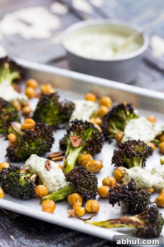 Roasted broccoli is a revelation! It’s a great way to cook this green, adding a welcome texture which can easily be ruined by boiling. Coated with garlic and olive oil, along with slightly crisped and browned edges, it brings a completely different flavour to this Brassica. Throwing in some chickpeas and a herb yoghurt rounds it off beautifully, making a truly engrossing vegetarian side dish to bring to the table.