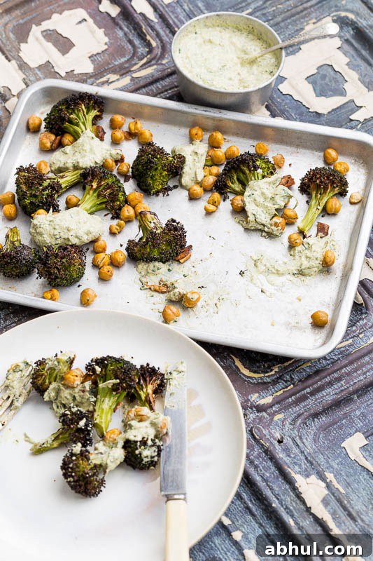 Roasted broccoli is a revelation! It’s a great way to cook this green, adding a welcome texture which can easily be ruined by boiling. Coated with garlic and olive oil, along with slightly crisped and browned edges, it brings a completely different flavour to this Brassica. Throwing in some chickpeas and a herb yoghurt rounds it off beautifully, making a truly engrossing vegetarian side dish to bring to the table.