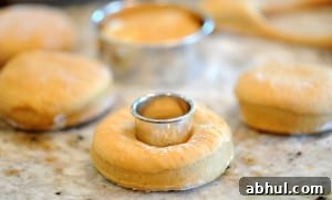 making hole in doughnut dough.