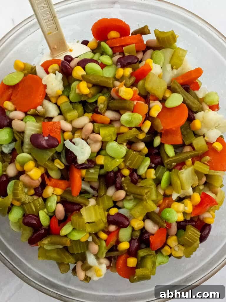 vegetables and beans mixed in a large bowl