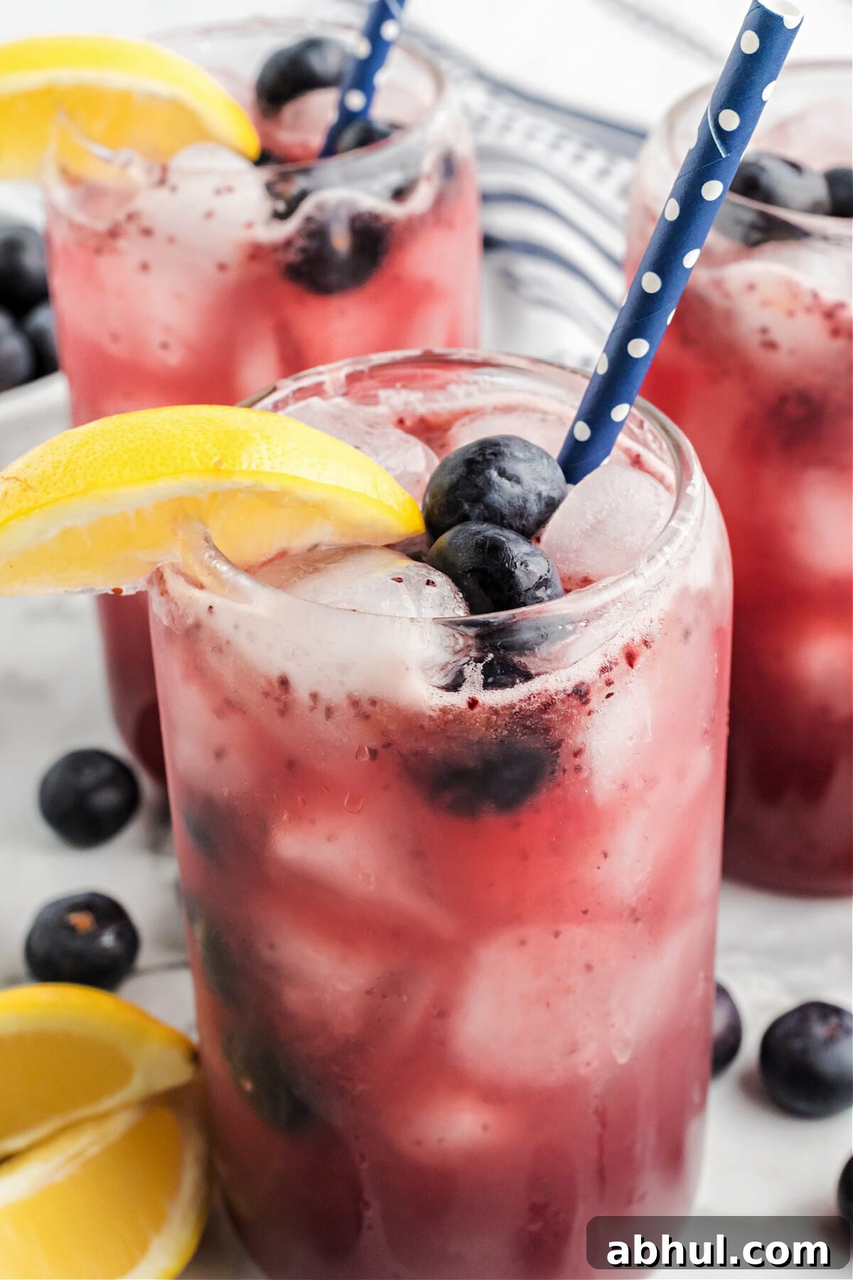 Refreshing Blueberry Lemonade Recipe with Fresh Citrus Twist 12 blueberry lemonade in glasses with blue straws