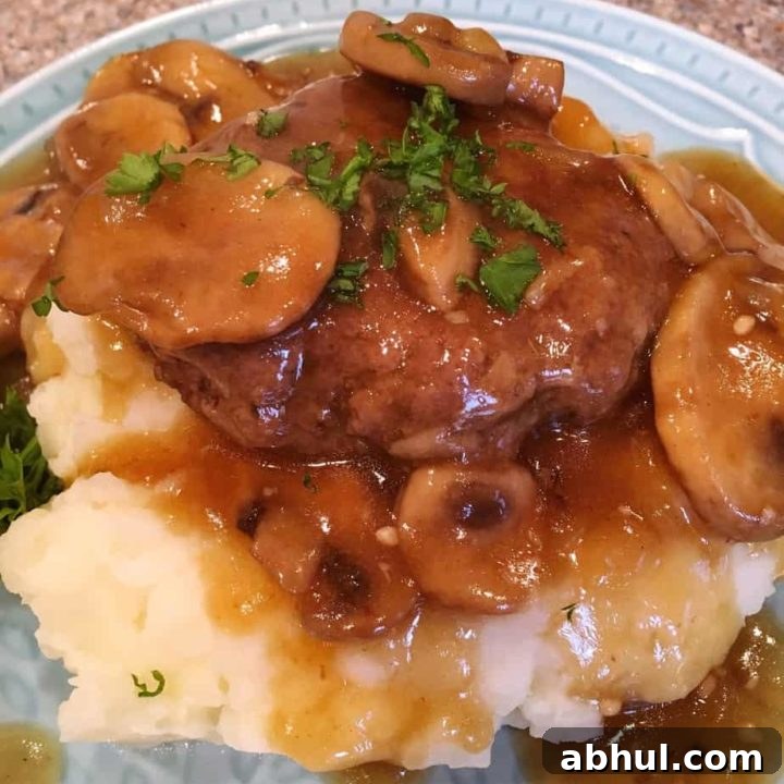 Salisbury Steak on top of mashed potatoes.