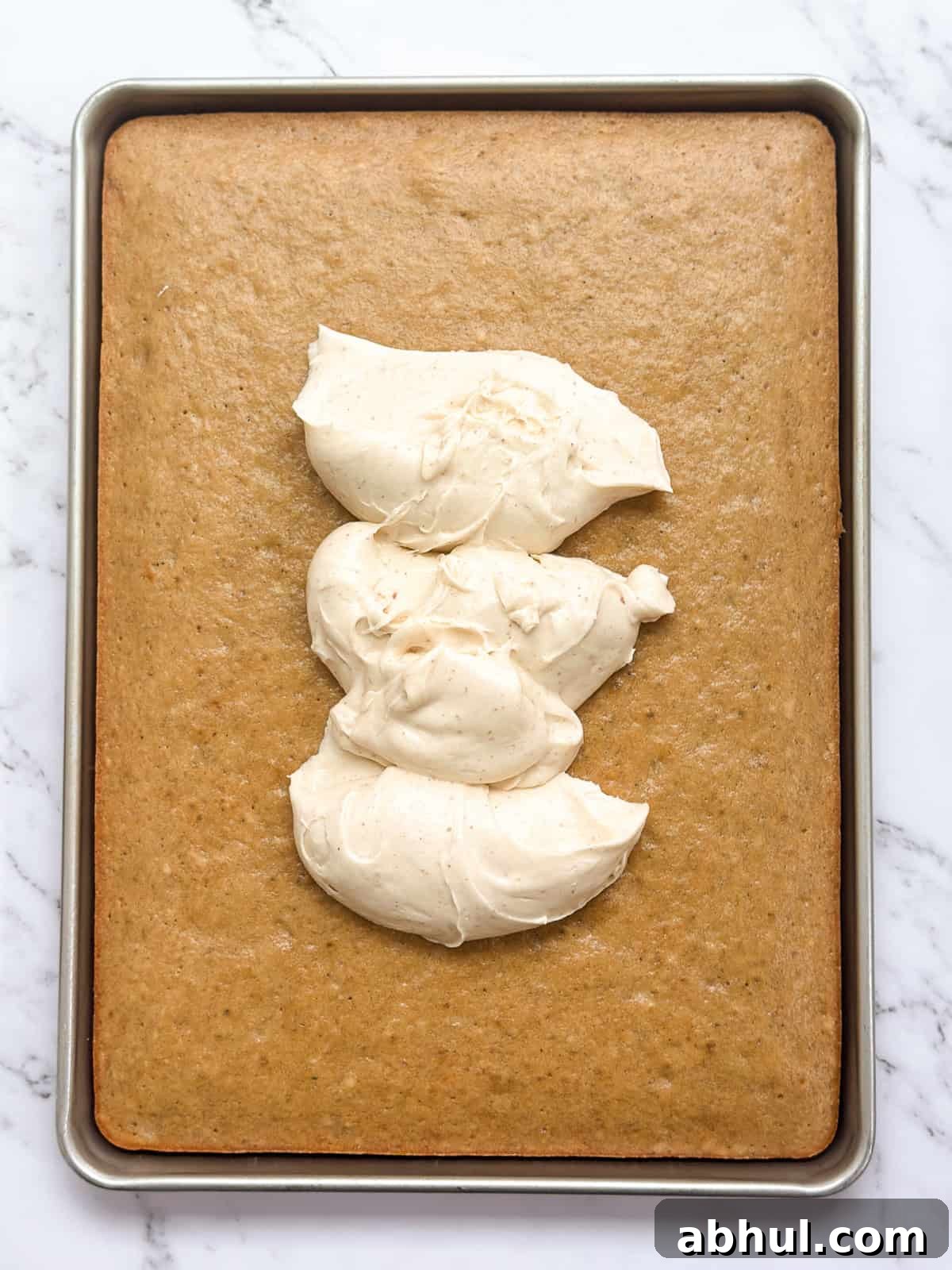 the banana sheet cake with some dollops of brown butter frosting on top.