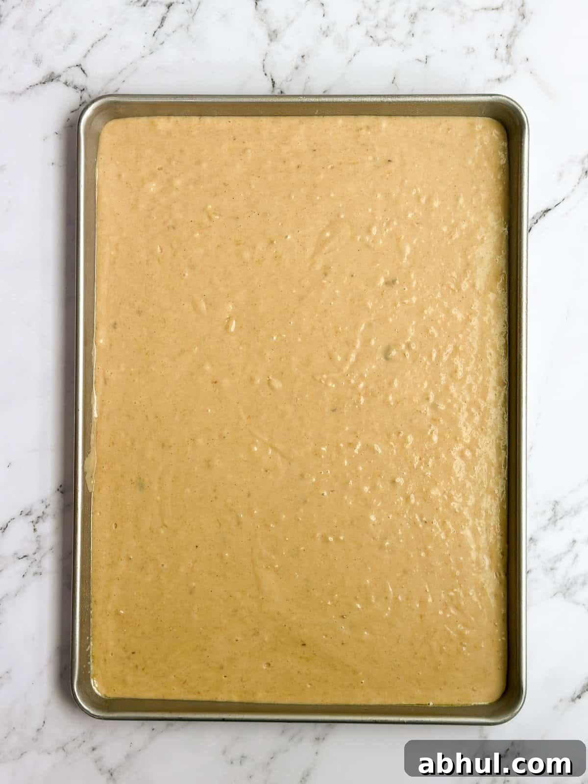 banana batter in the sheet cake pan before baking.