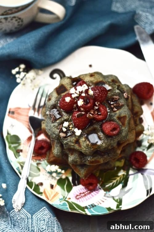 Paleo Berry Coconut Waffles are the perfect grain free breakfast. Made without any dairy these waffles still taste amazing! Serve these paleo berry waffles at your next brunch and they are sure to be a hit! #paleo #waffles #pancakes #breakfast #glutenfree