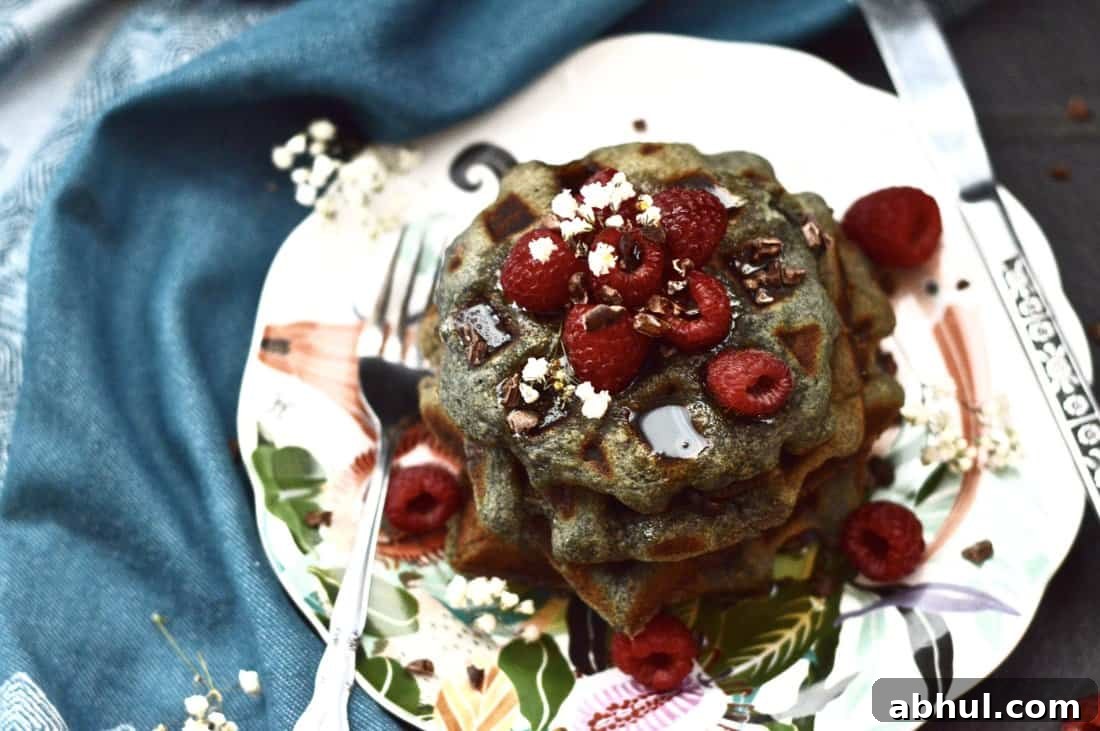 Paleo Berry Coconut Waffles are the perfect grain free breakfast. Made without any dairy these waffles still taste amazing! Serve these paleo berry waffles at your next brunch and they are sure to be a hit! #paleo #waffles #pancakes #breakfast #glutenfree