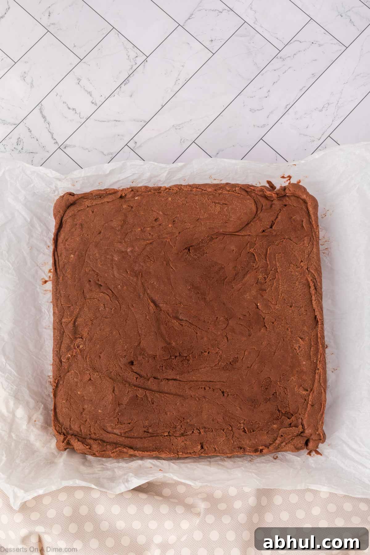 Fudge removed from pan with parchment paper. 