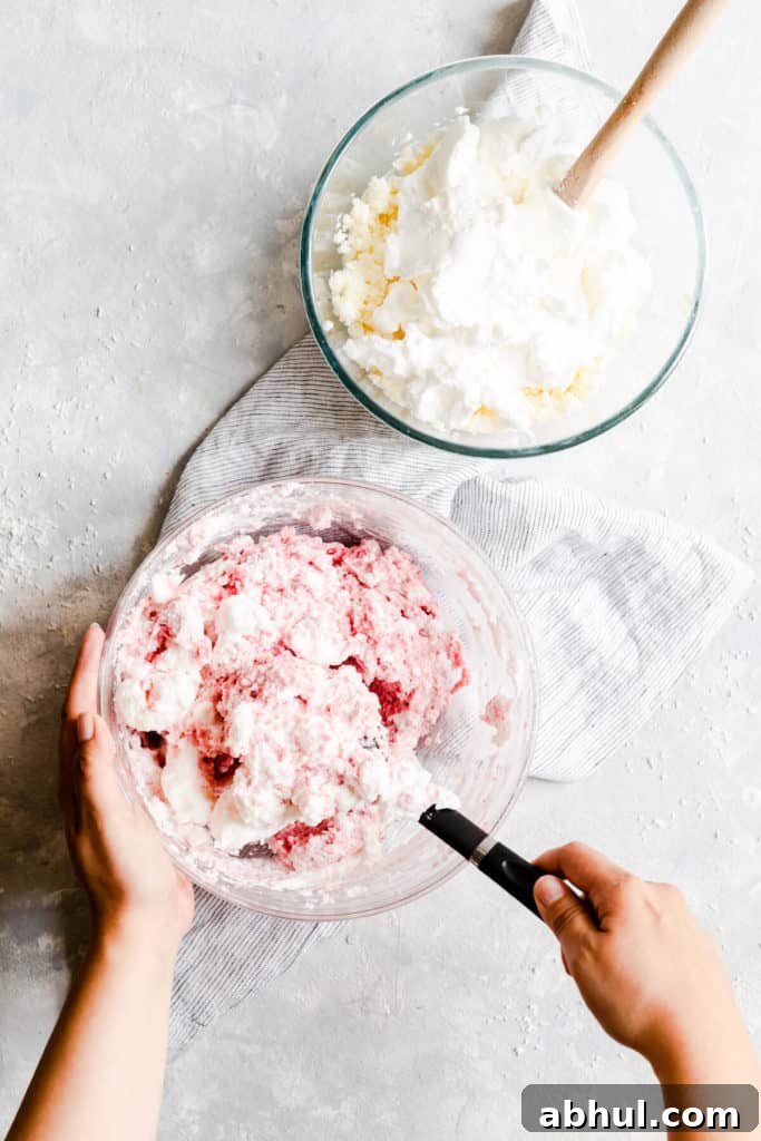 Strawberry Coconut Frozen Squares: Refreshing No-Bake Treat 15 overhead shot showing meringue being folded into coconut