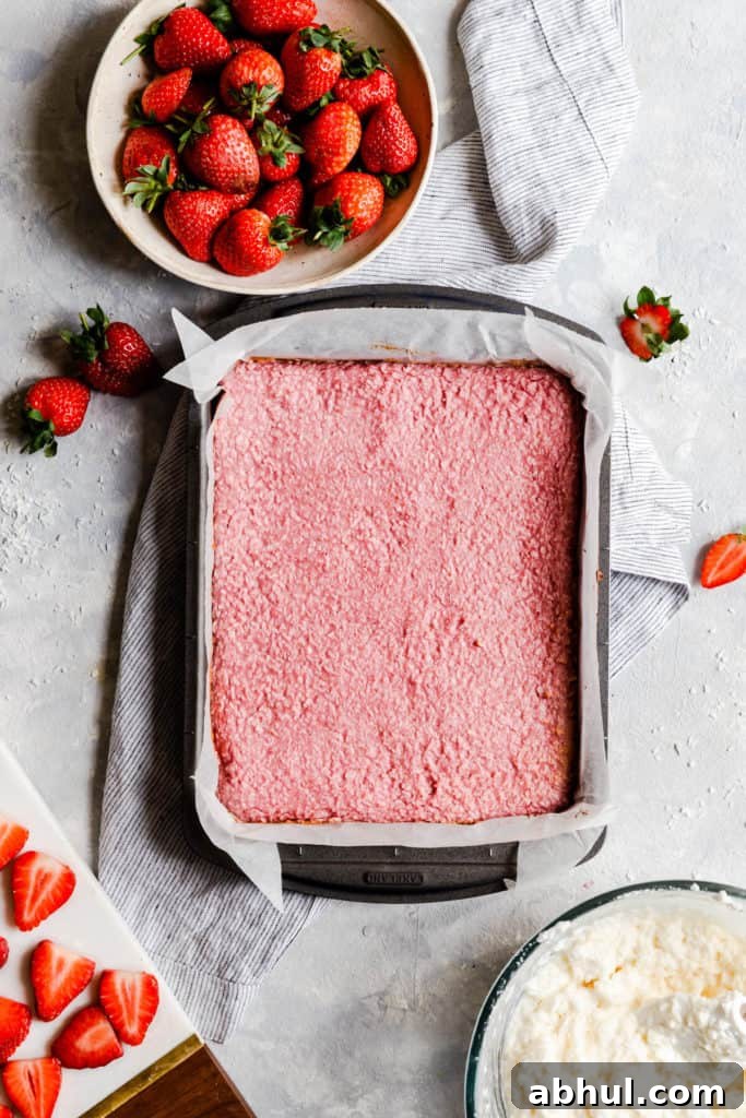 Strawberry Coconut Frozen Squares: Refreshing No-Bake Treat 17 top view of baked strawberry coconut mix in a baking tin