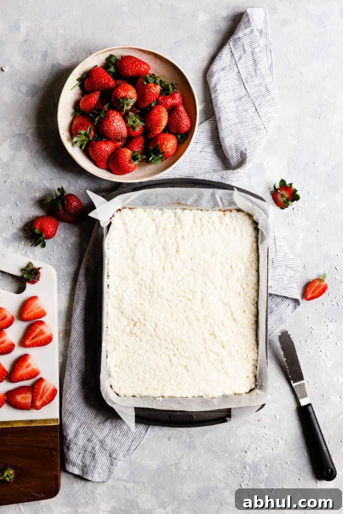 Strawberry Coconut Frozen Squares: Refreshing No-Bake Treat 19 overhead shot of baking tin with coconut bake