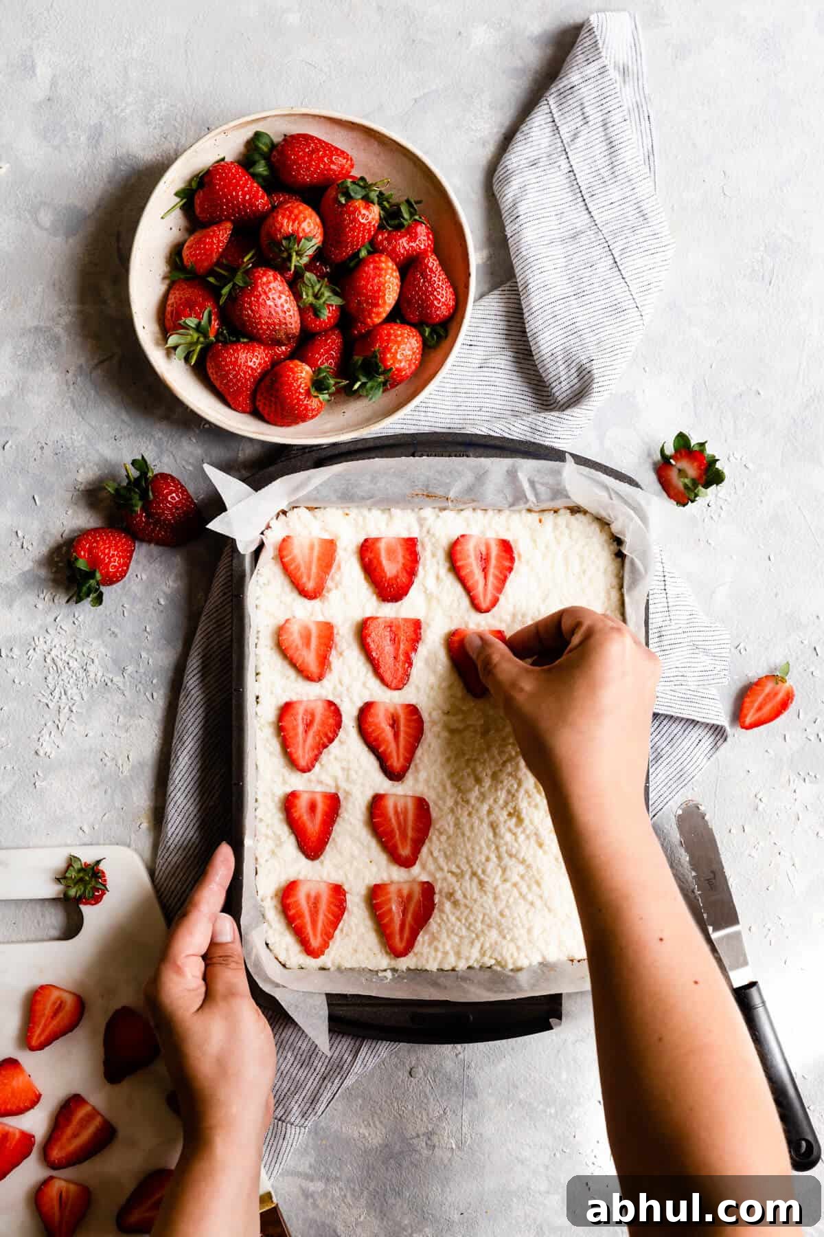 Strawberry Coconut Frozen Squares: Refreshing No-Bake Treat 20 top view of strawberry slices being placed on top of the coconut bake