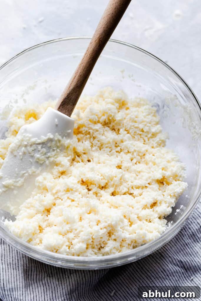 Strawberry Coconut Frozen Squares: Refreshing No-Bake Treat 10 side close up of a bowl with coconut and condensed milk mixture