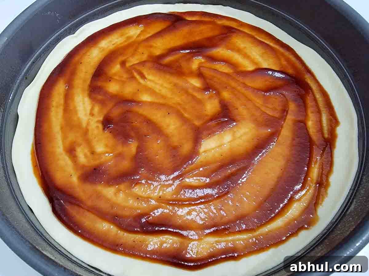 pizza dough covered in pizza sauce.