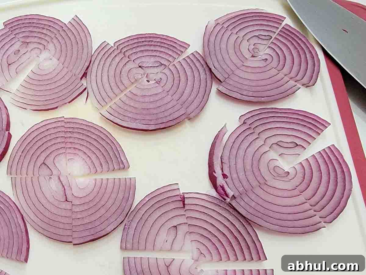 sliced red onions on a cutting board.
