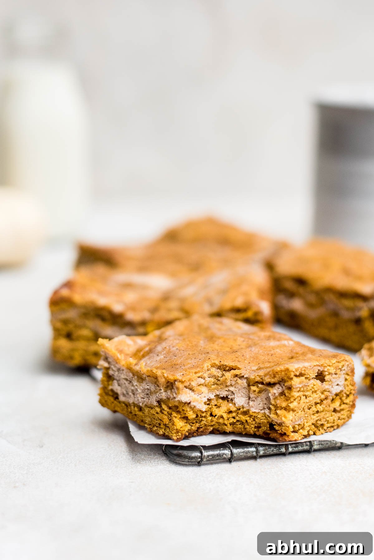 close up pumpkin cheesecake bars on wire rack