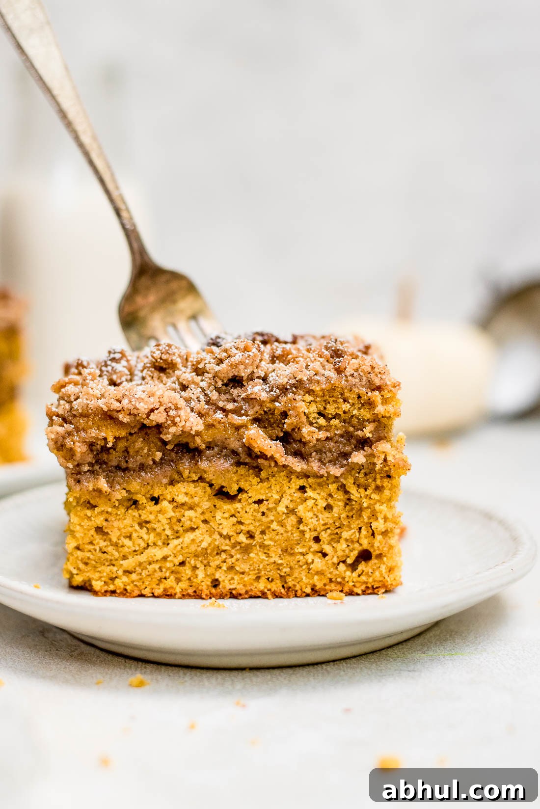 Close up pumpkin coffee cake with fork in cake