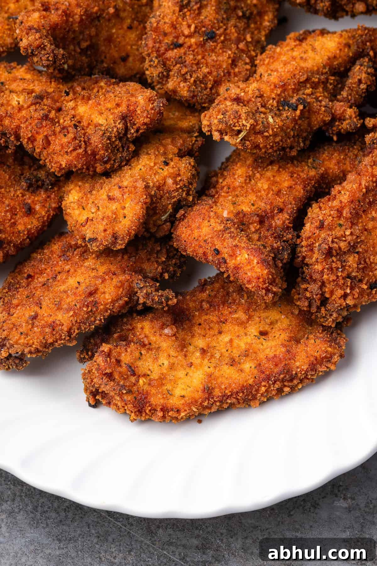 Close up of a platter of crispy chicken stuffing chicken tenders.