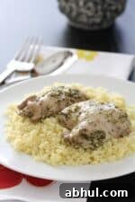 A Plate of Pesto Chicken Thighs over Couscous