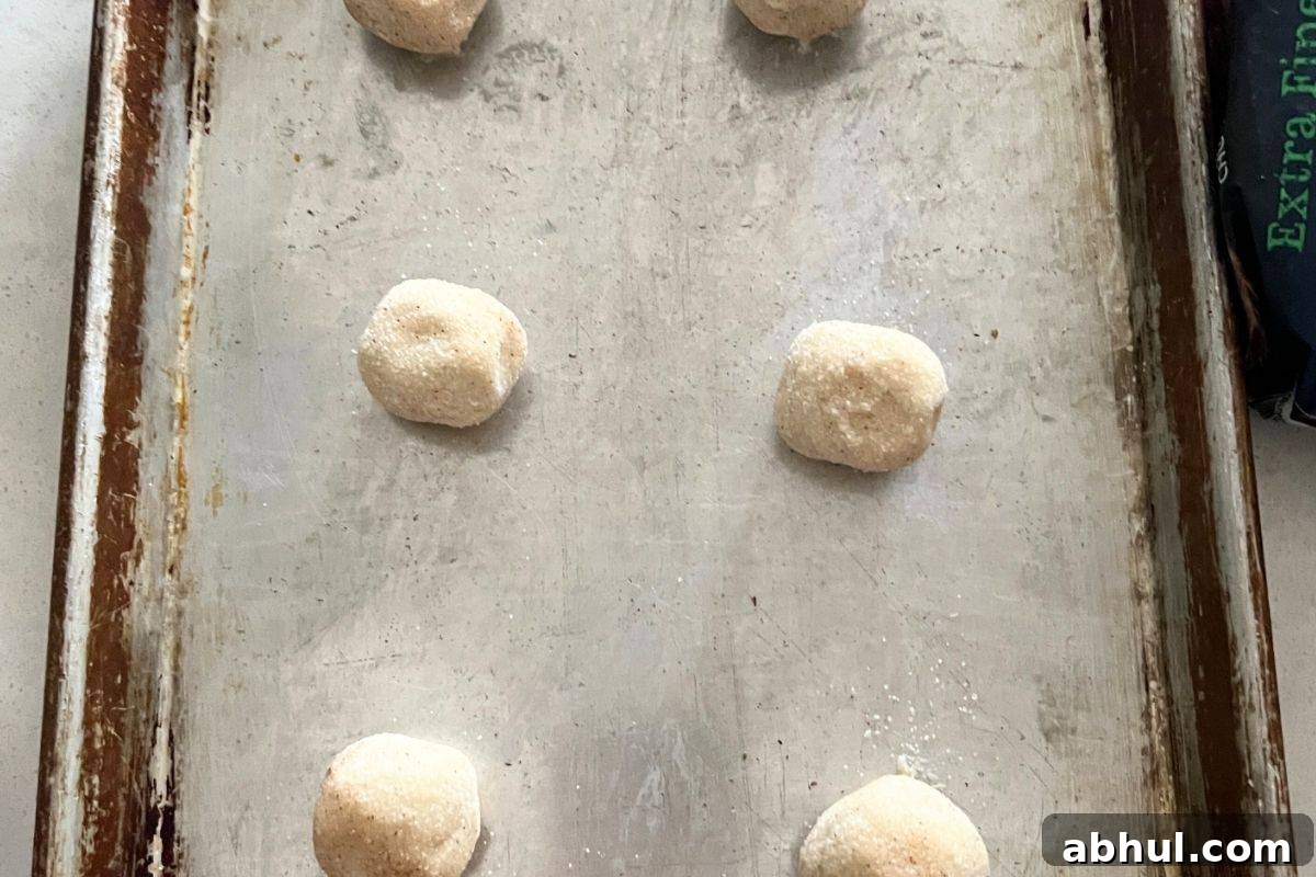 Rolled cookie dough balls on parchment
