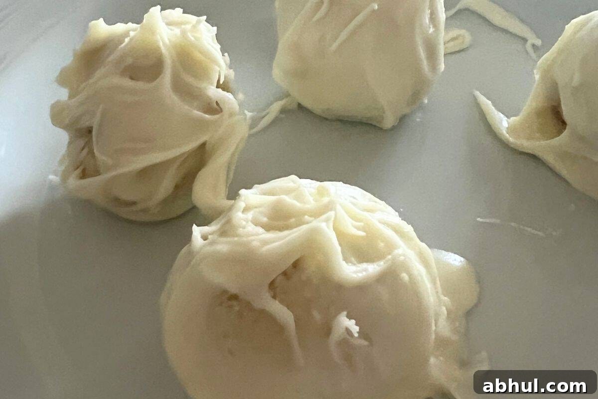 Dipped cookie dough balls in white chocolate