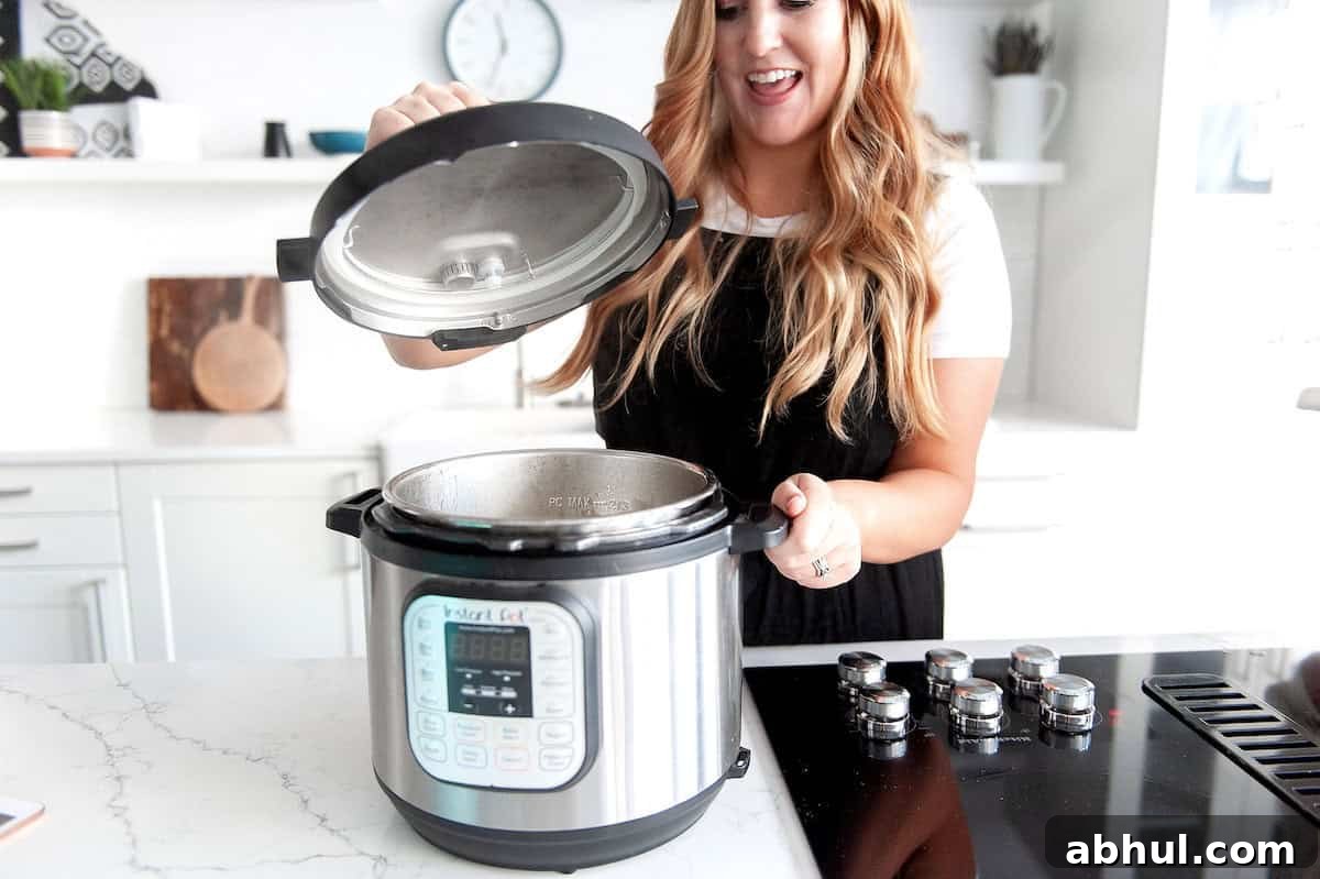 15 Smart Tips for Meal Prep and Freezer-Friendly Recipes 4 woman checking on cooked food in the instant pot