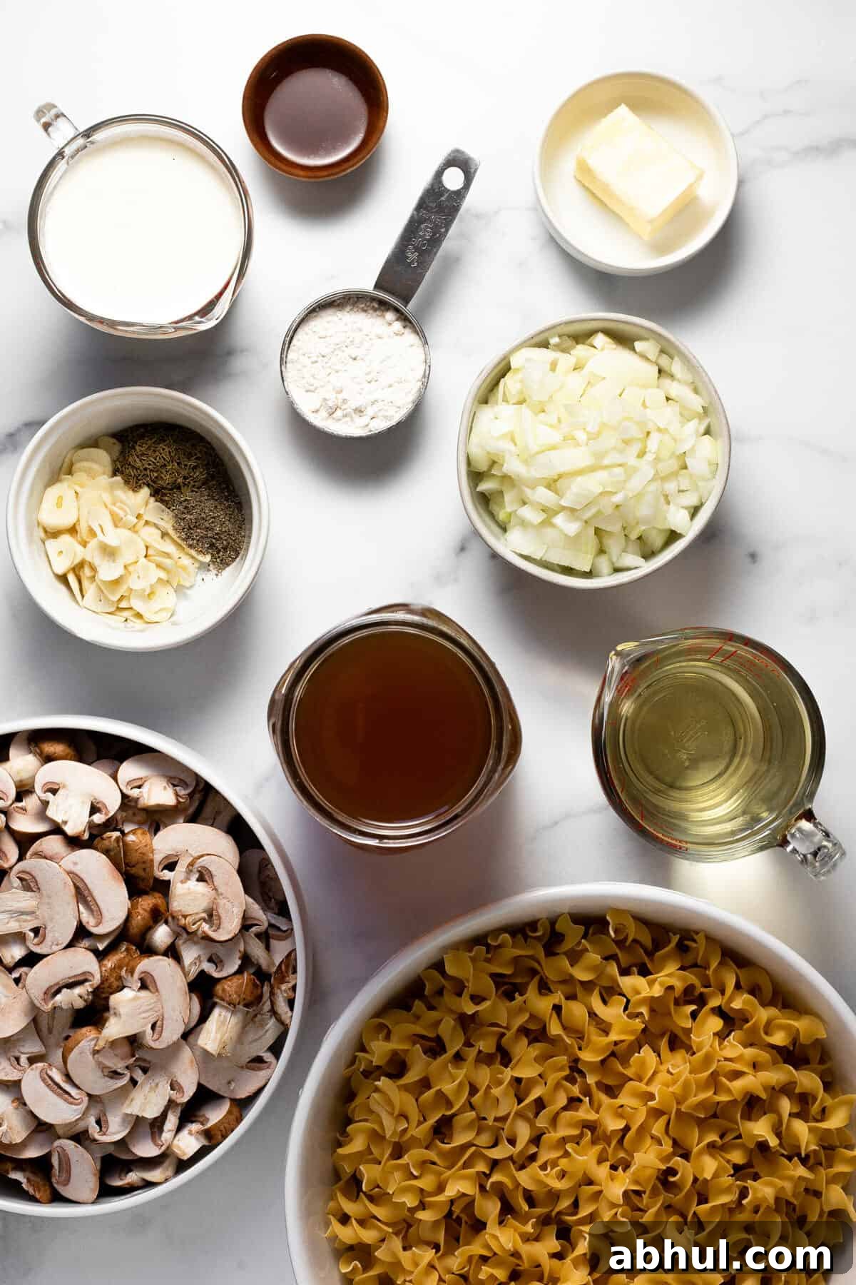 White marble counter top with ingredients to make vegetarian mushroom stroganoff