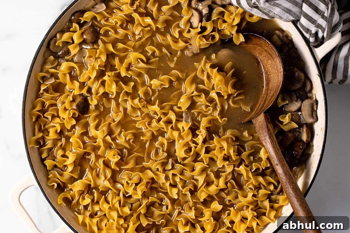 Large pan filled with ingredients to make one pot mushroom stroganoff