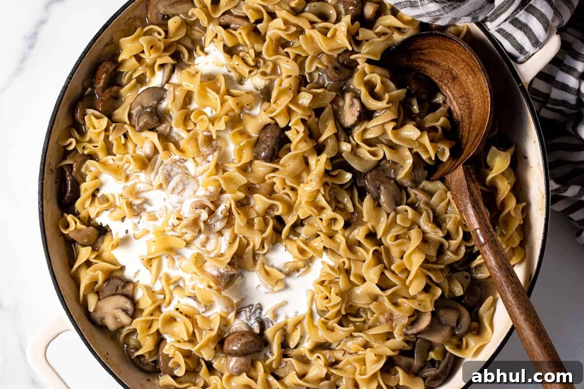 Large pan filled with ingredients to make one pot mushroom stroganoff