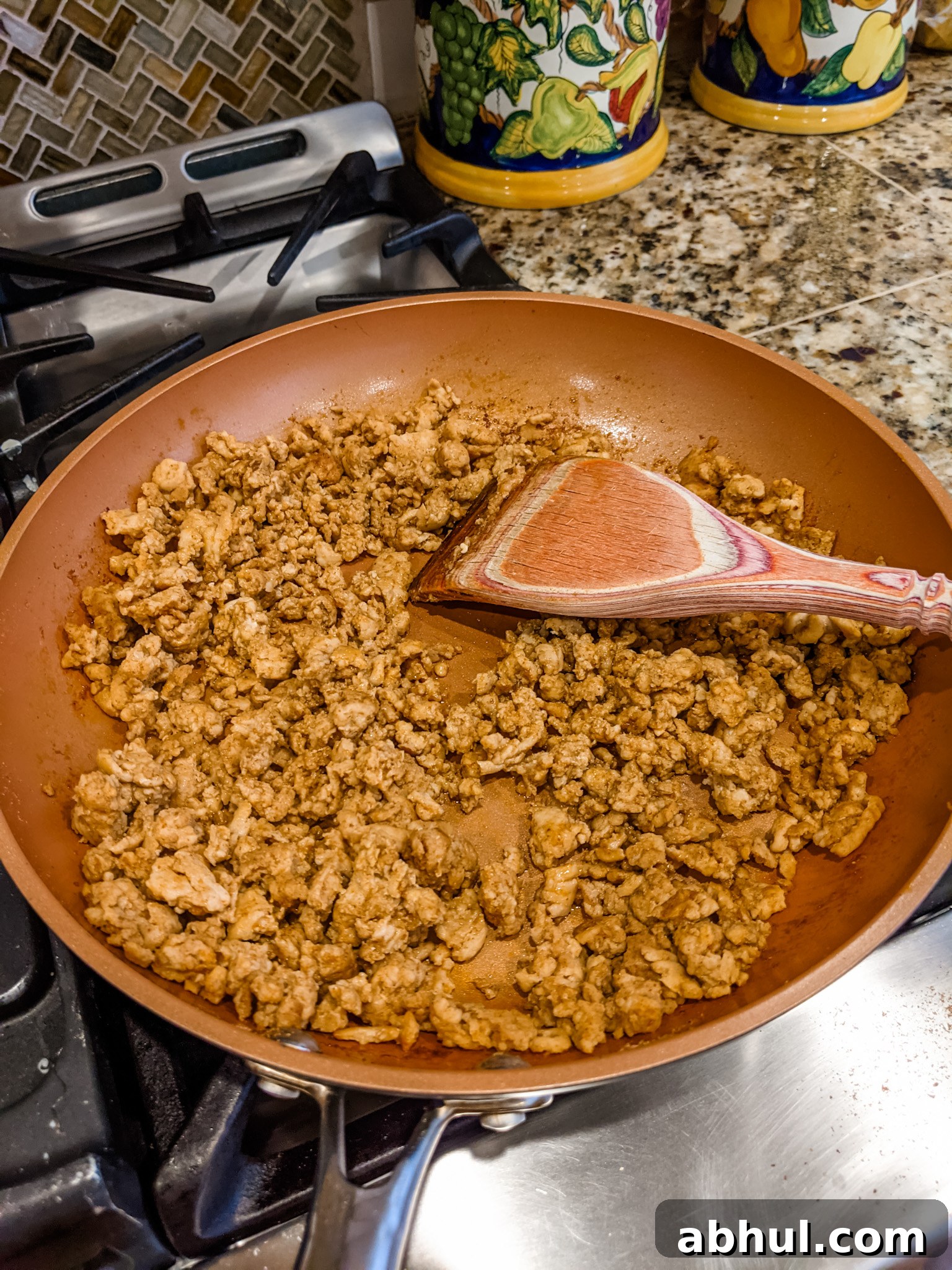 Chicken with taco mix, browning in a pan.