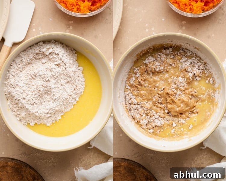 Dry ingredients added to wet ingredients in a bowl and gently folded together to form muffin batter.