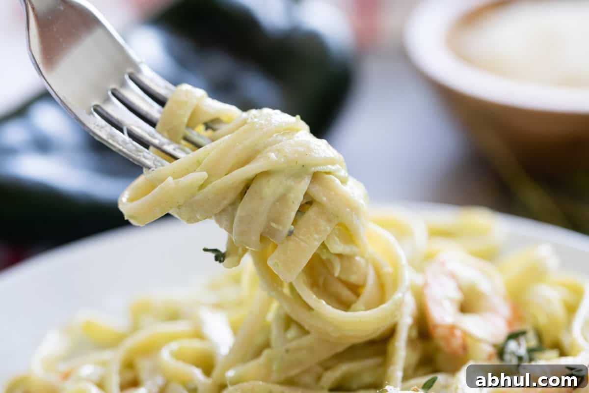 Linguine with poblano cream sauce twirled on a fork.