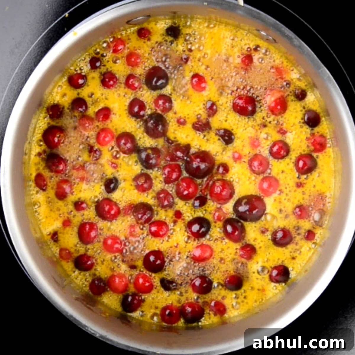 whole cranberries cooking in orange juice