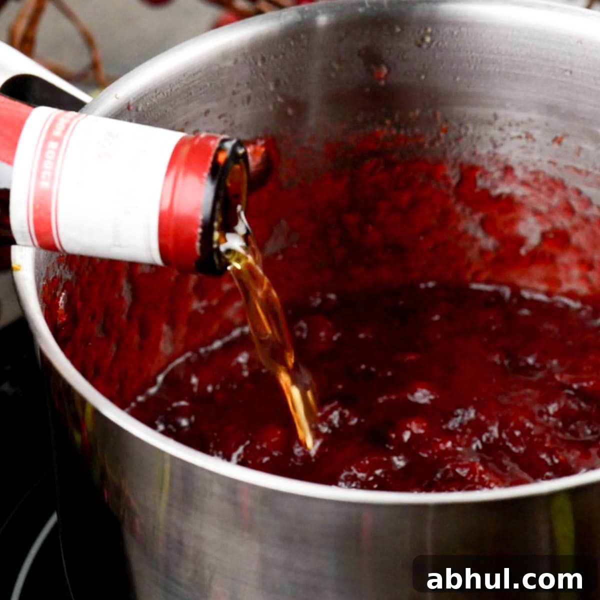 adding Grand Marnier to homemade cranberry sauce