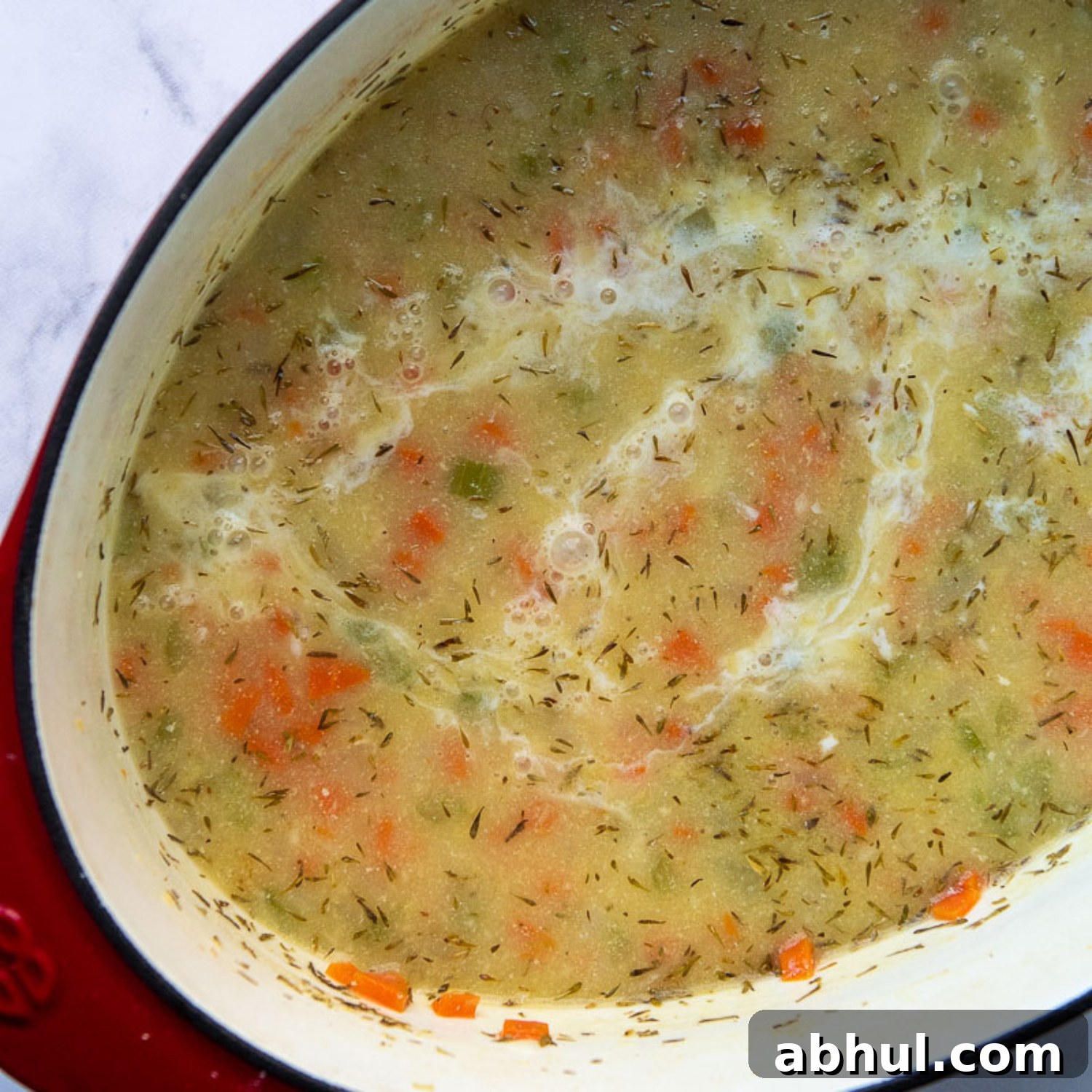 the evaporated milk being added to the make the soup creamy.