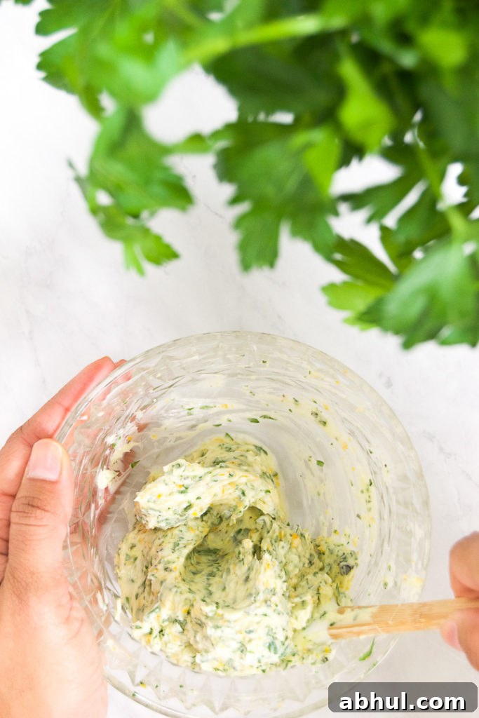 Herb-Butter Compound for Juicy Roasted Turkey 2 A person stirs a bowl of orange garlic compound butter