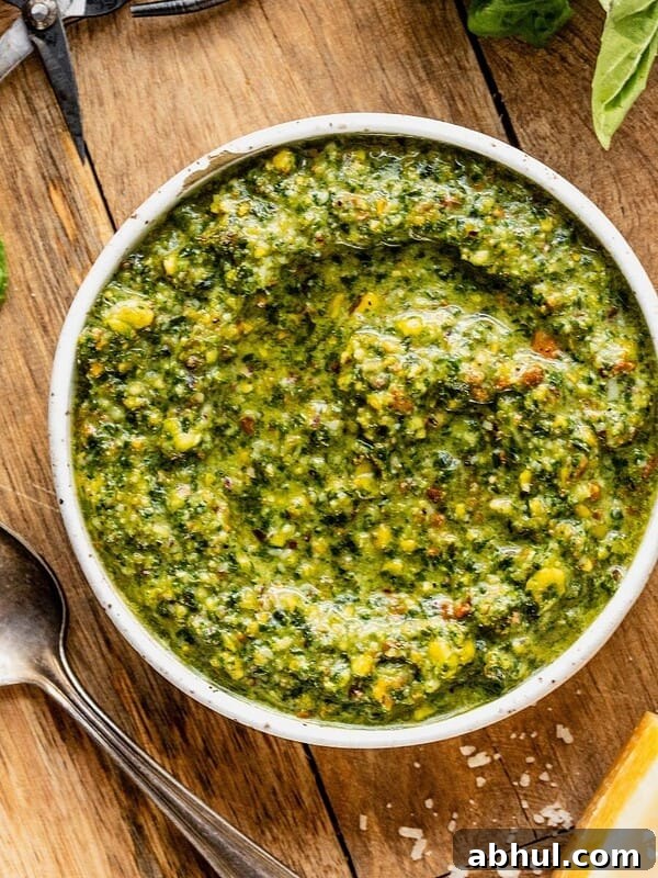 Bowl of pistachio pesto on a wooden tray.